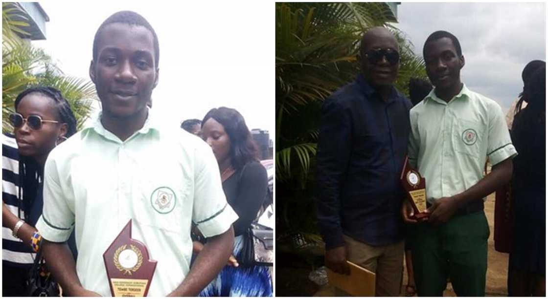 Nigerian secondary school student holding award plaque and standing with a man. Nigerian secondary school student holding award plaque and standing with a man.