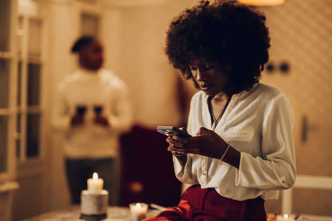 A woman looks at her phone at the hallway. A woman looks at her phone at the hallway.