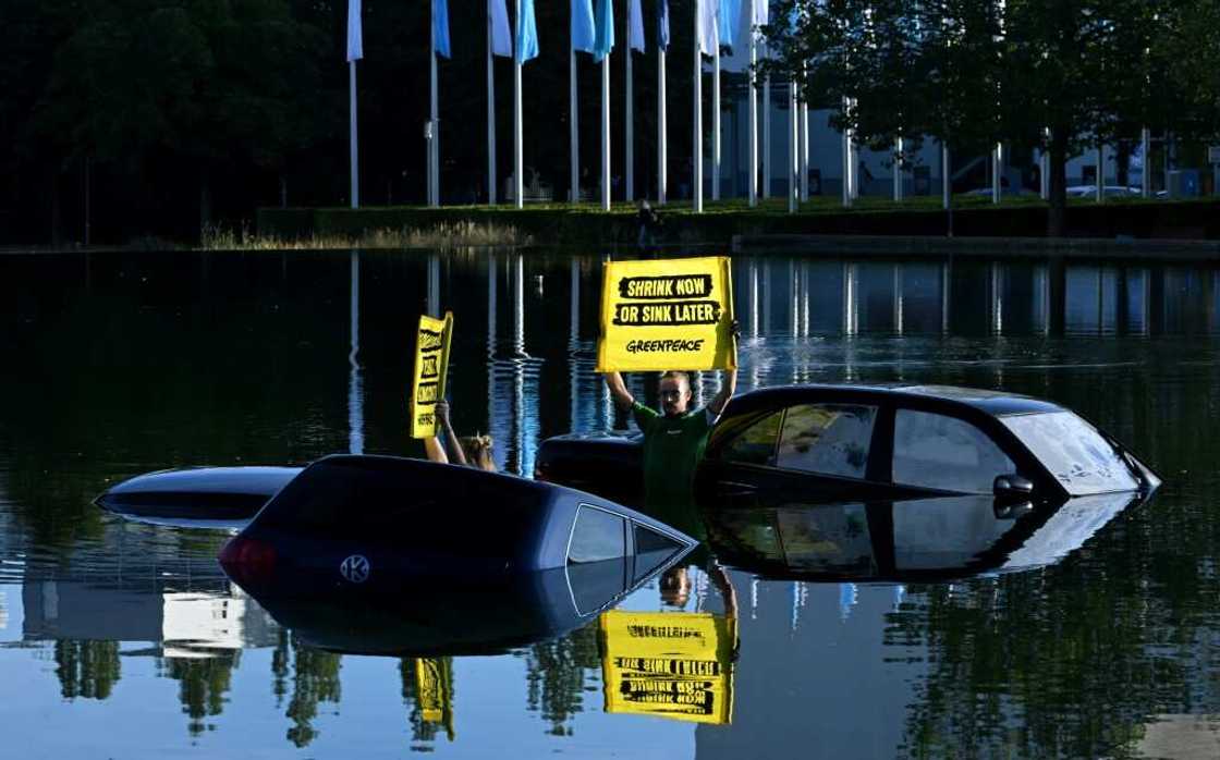 Greenpeace activists submerged three cars in a small lake outside the IAA convention centre Greenpeace activists submerged three cars in a small lake outside the IAA convention centre
