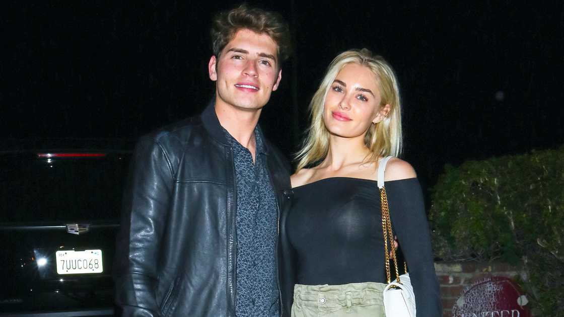 Gregg Sulkin and Michelle Randolph pose while holding each other
