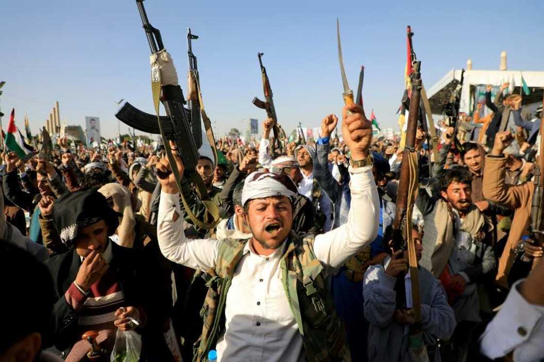 Huthi fighters brandish their weapons during a protest in the rebel-held capital, Sanaa, on Friday Huthi fighters brandish their weapons during a protest in the rebel-held capital, Sanaa, on Friday