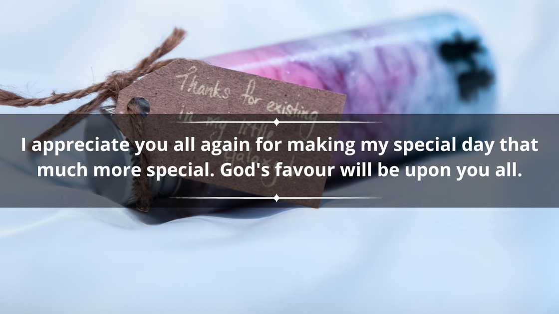 A thank you card on a small blue and pink bottle