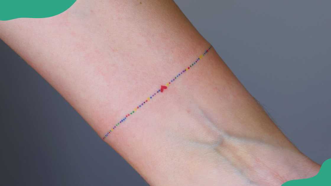 Delicate and colourful bracelet tattoo