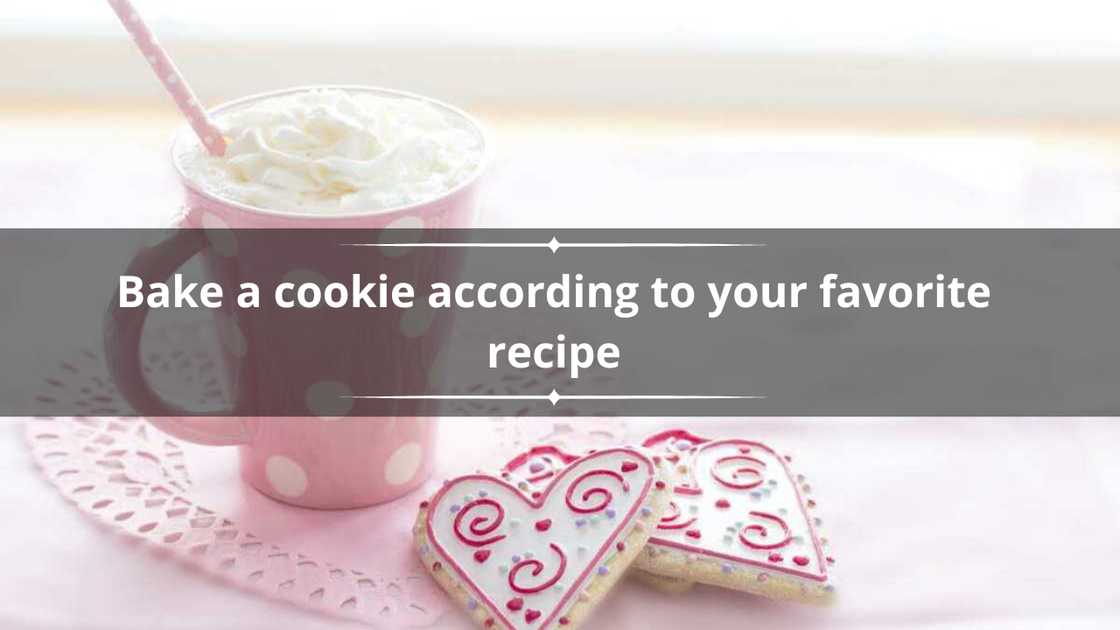 Heart shaped cookies served with a foamy drink in a pink cup Heart shaped cookies served with a foamy drink in a pink cup