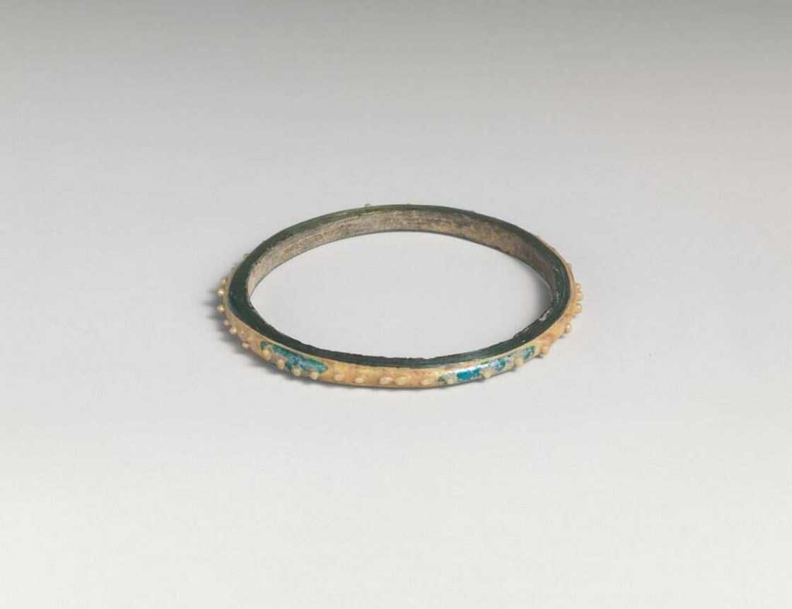 A ring on a pale blue-green surface A ring on a pale blue-green surface