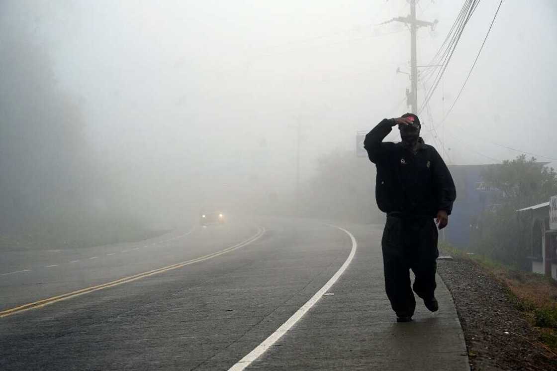 A man walks along a road in the town of Santa Ana, in Honduras's Francisco Morazan department, on October 9, 2022, shortly before the arrival of Hurricane Julia A man walks along a road in the town of Santa Ana, in Honduras's Francisco Morazan department, on October 9, 2022, shortly before the arrival of Hurricane Julia