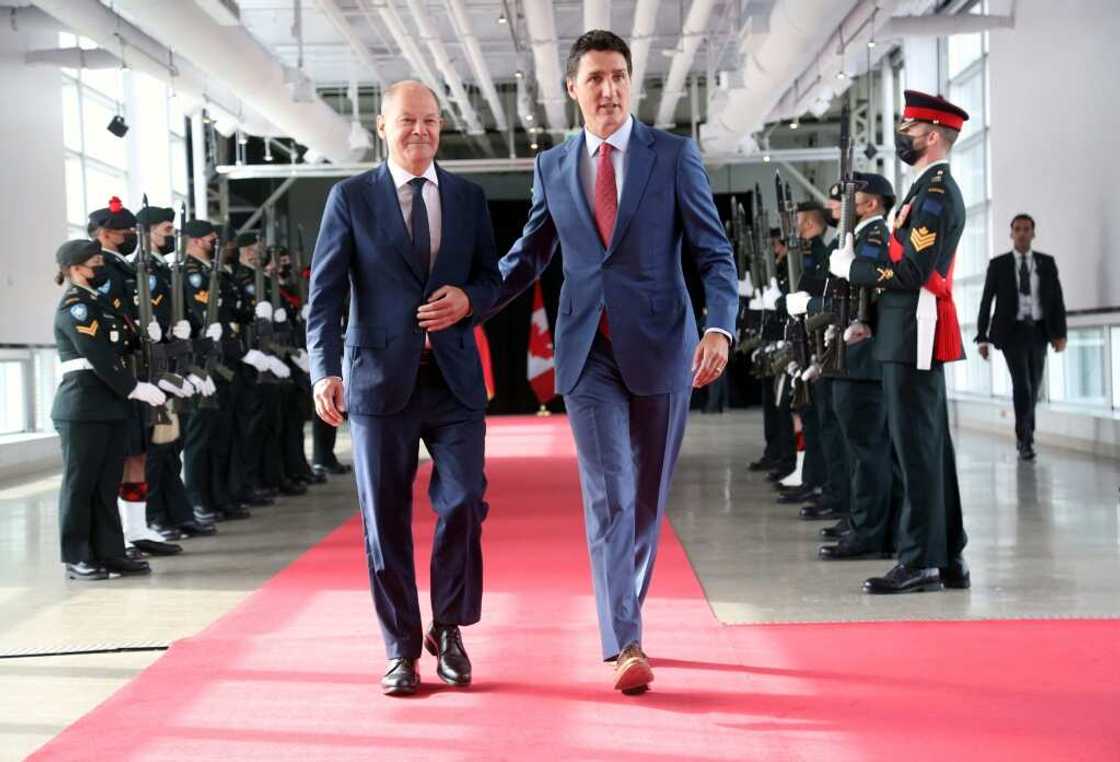 Canada's Prime Minister Justin Trudeau (R) welcomes visiting German Chancellor Olaf Scholz before their meeting at the Montreal Science Centre to discuss energy trade