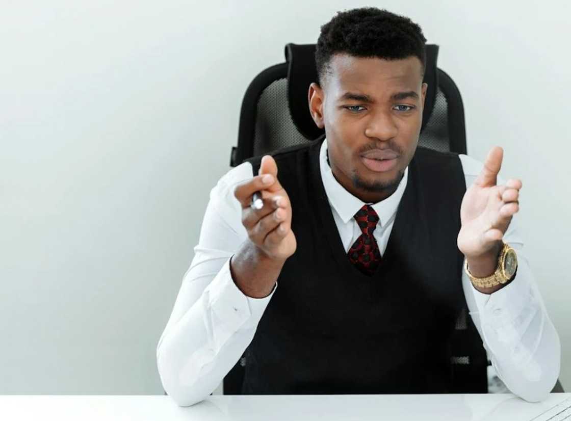 A serious young man in the middle of a conversation in the office A serious young man in the middle of a conversation in the office