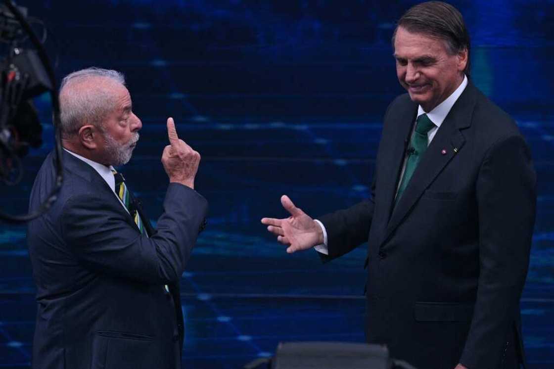 Former president Luiz Inacio Lula da Silva (L), and President Jair Bolsonaro (R) gesture during a televised debate ahead of Brazil's runoff election in two weeks Former president Luiz Inacio Lula da Silva (L), and President Jair Bolsonaro (R) gesture during a televised debate ahead of Brazil's runoff election in two weeks