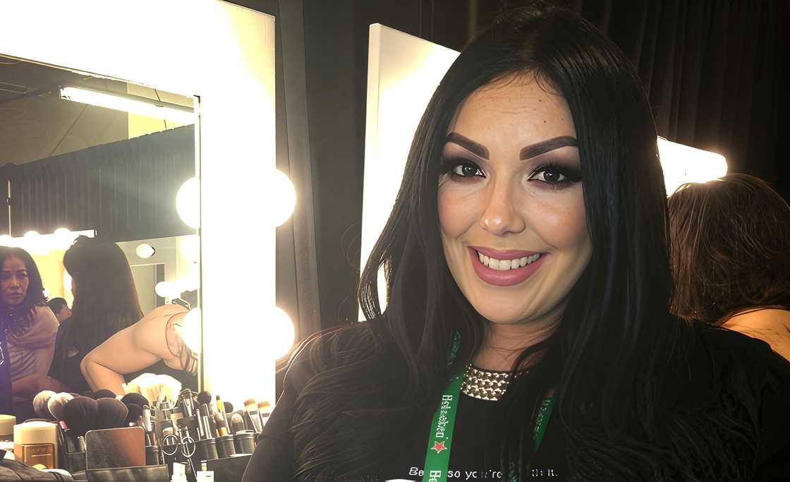 Ceci De La Hoya poses backstage infront of a make-up station.