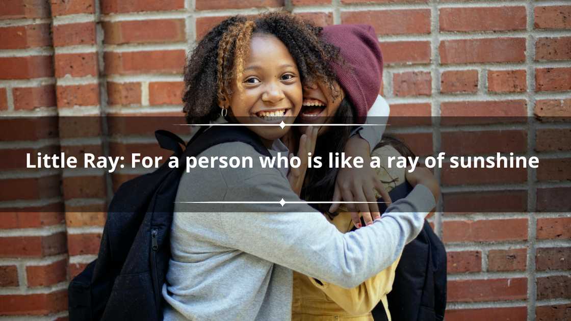 Happy friends are pictured hugging each other in front of a brick wall