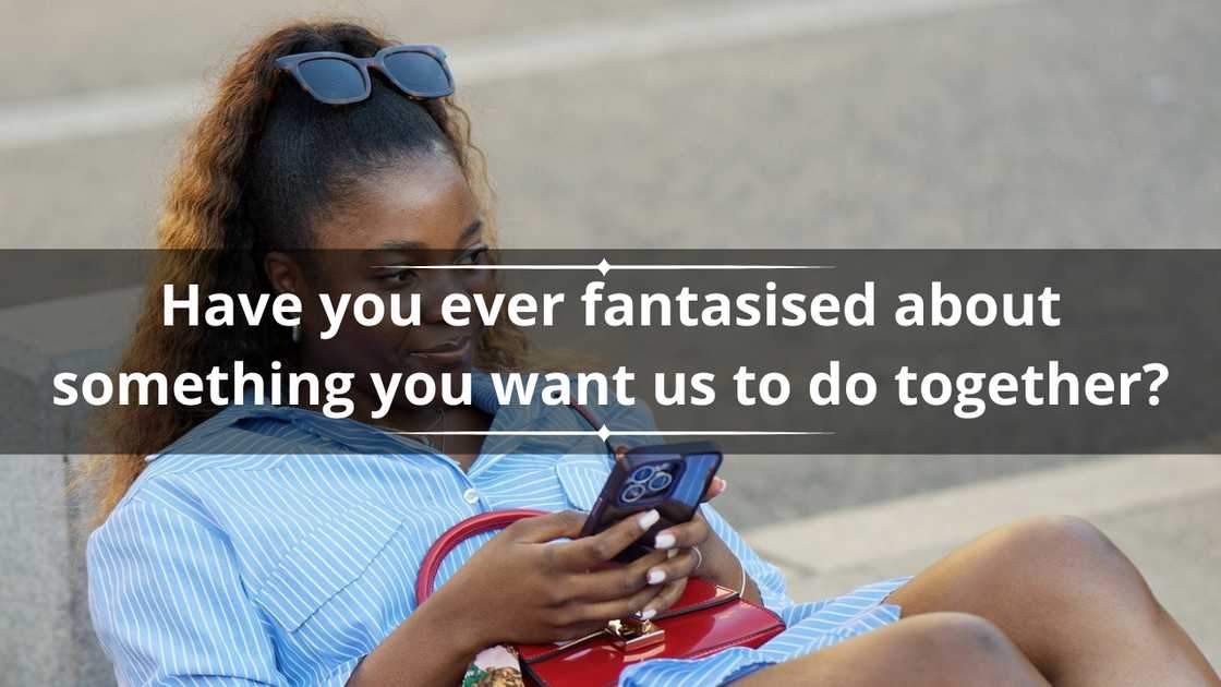 A woman in a blue striped dress is pictured while using her smartphone