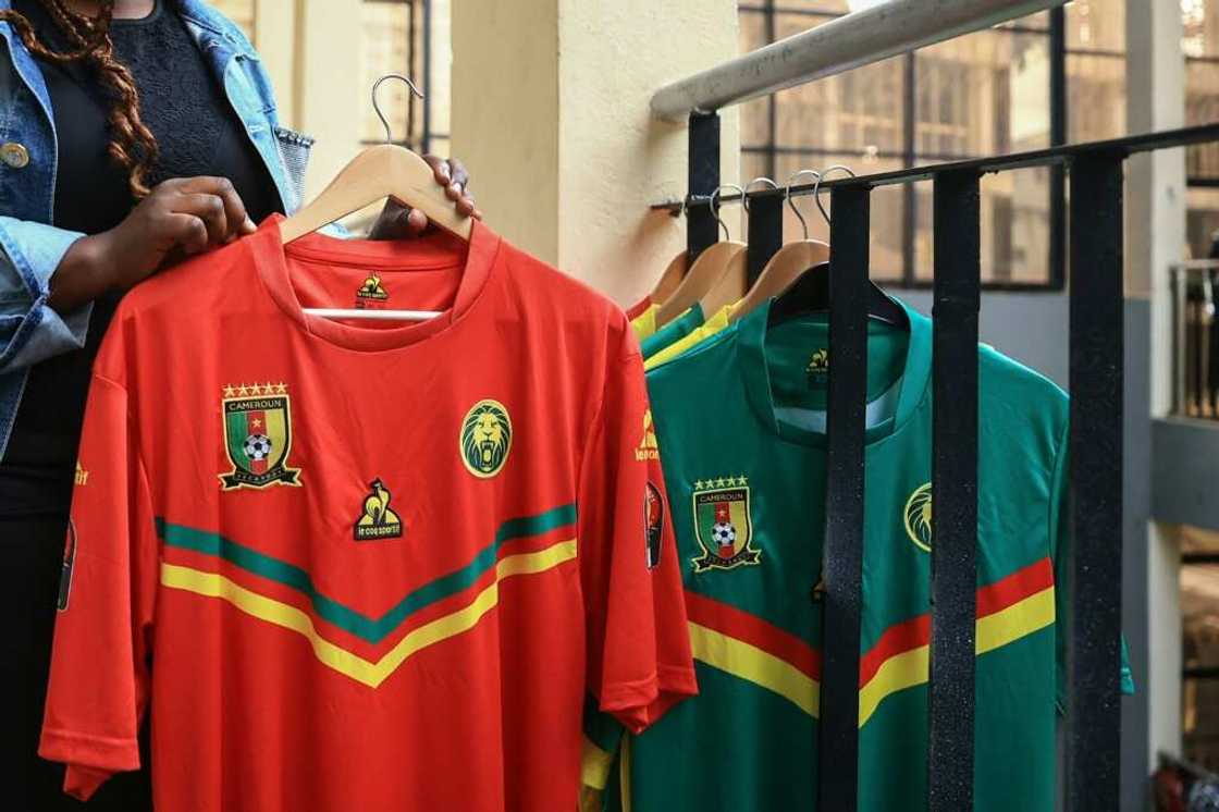 Racks of out-of-date Indomitable Lions shirts with the Coq Sportif logo await customers in a Yaounde sports shop Racks of out-of-date Indomitable Lions shirts with the Coq Sportif logo await customers in a Yaounde sports shop
