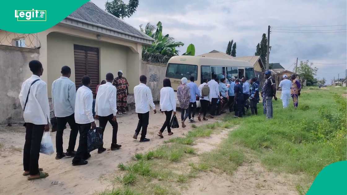 Rescued students gathered outside the apartment used as a suspected fake university in Lagos.