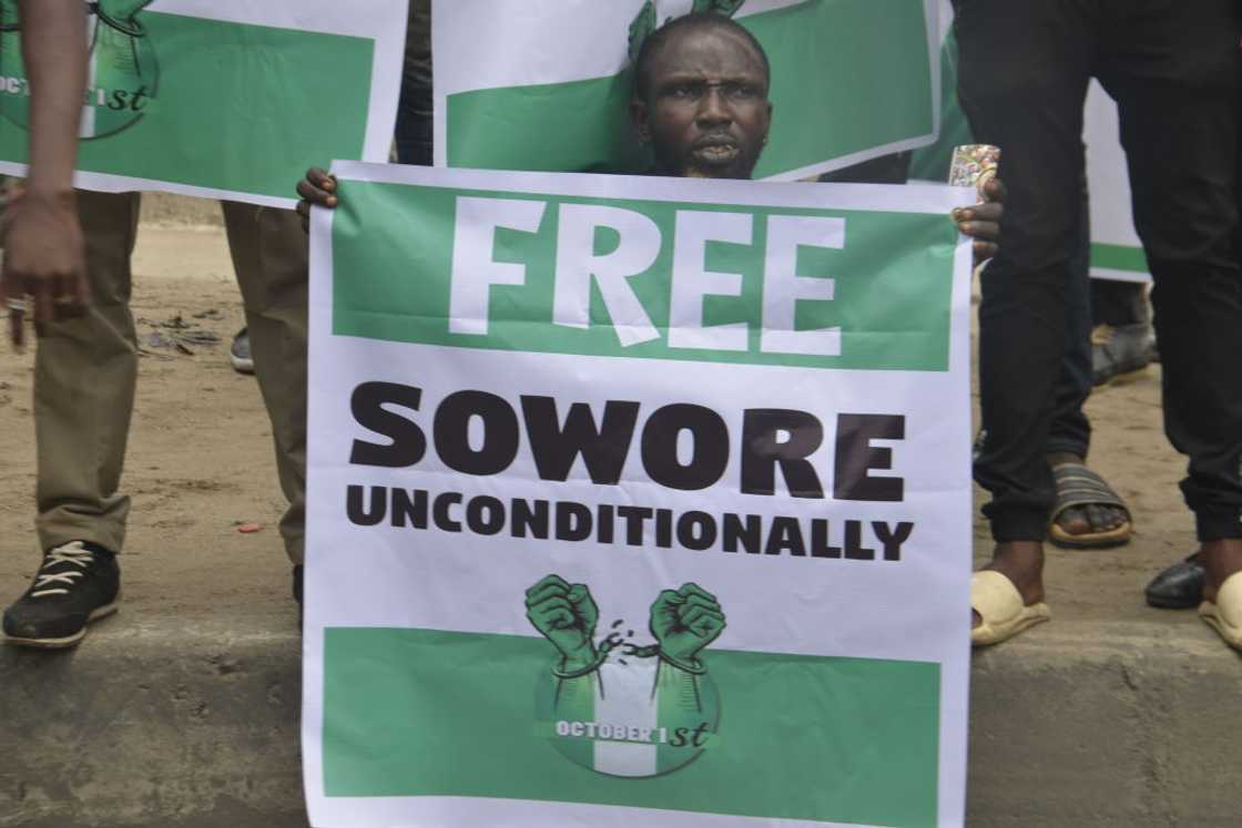 A protester holding a green and white "Free Sowore Unconditionally" banner during a demonstration in Ojota, Lagos A protester holding a green and white "Free Sowore Unconditionally" banner during a demonstration in Ojota, Lagos