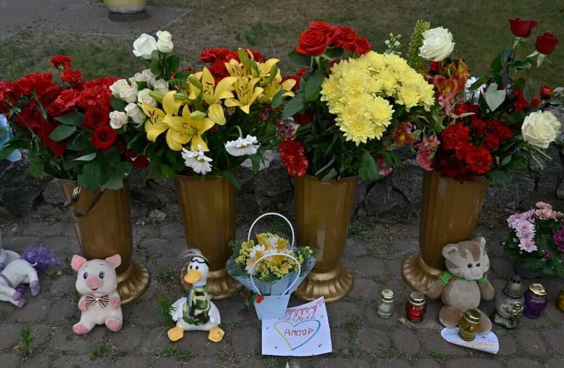 A makeshift shrine of candles, flowers and children's toys stands next to a destroyed mall in Kremenchuk on June 28, 2022, a day after it was hit by a Russian missile strike according to Ukrainian authorities. A makeshift shrine of candles, flowers and children's toys stands next to a destroyed mall in Kremenchuk on June 28, 2022, a day after it was hit by a Russian missile strike according to Ukrainian authorities.