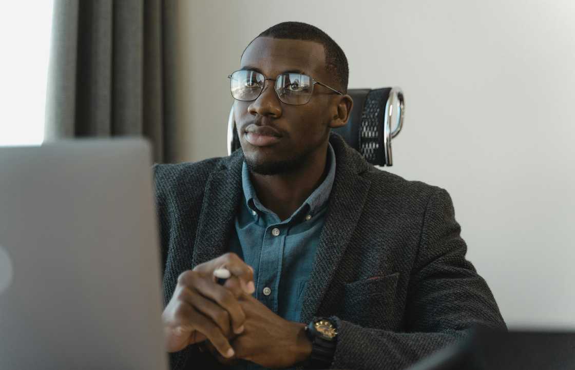 A man in gray suit using a laptop A man in gray suit using a laptop