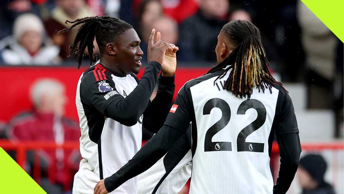 Calvin Bassey and Alex Iwobi celebrate a goal against Manchester United.