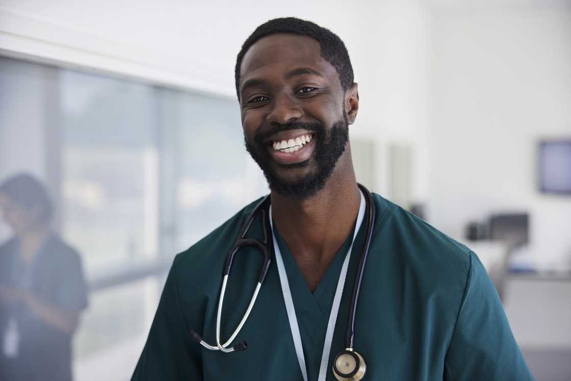 A male doctor in scrubs. A male doctor in scrubs.