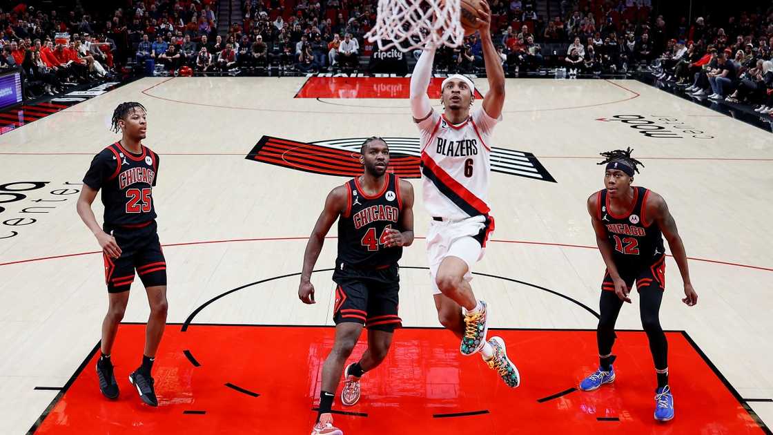 Keon Johnson of the Portland Trail Blazers jumps to the net (White).