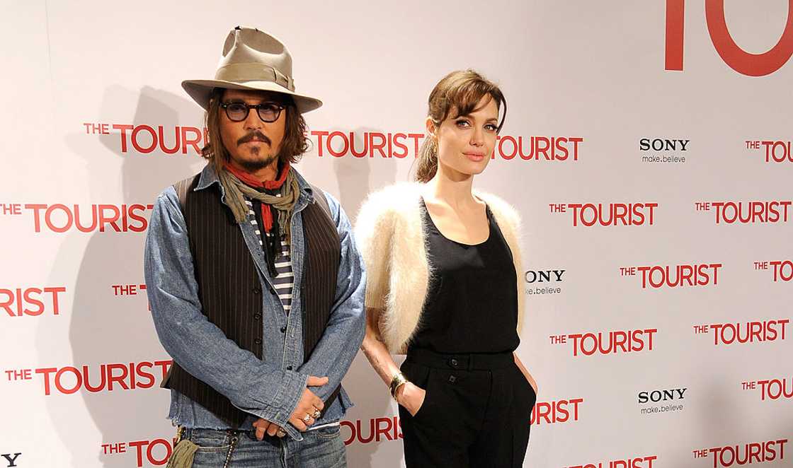 Johnny Depp (L) and Angelina Jolie attend a film event in Madrid, Spain
