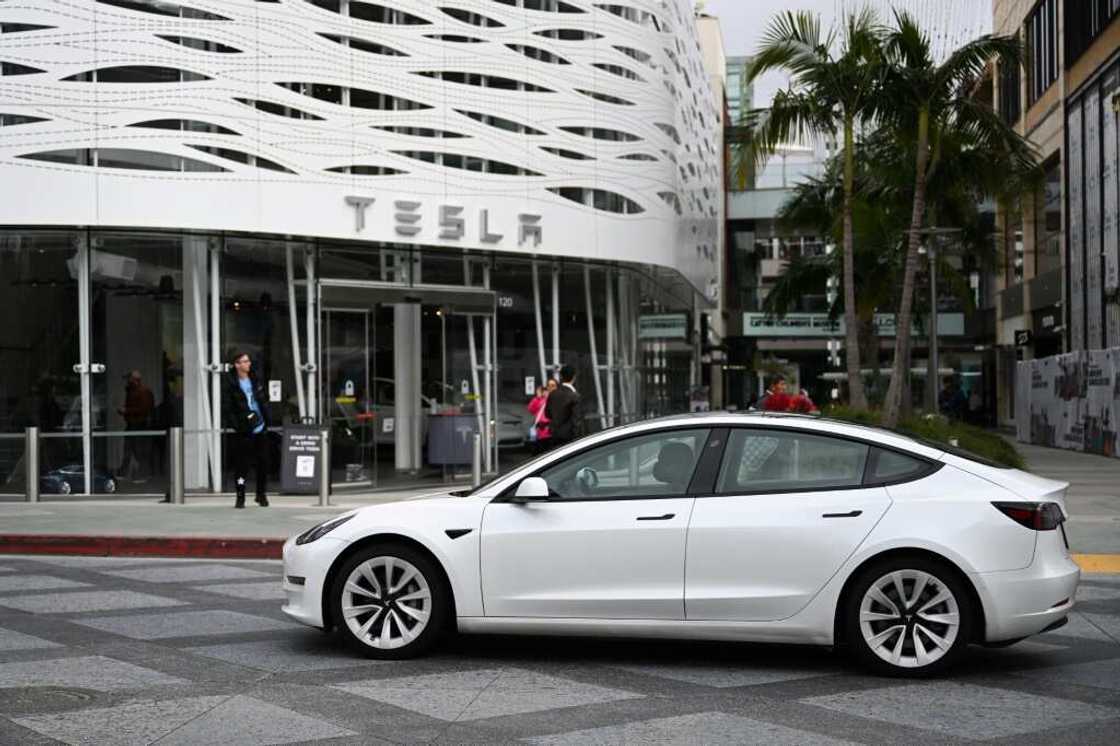 A Tesla electric vehicle drives past the Tesla Inc Santa Monica Place store, in Santa Monica, California A Tesla electric vehicle drives past the Tesla Inc Santa Monica Place store, in Santa Monica, California