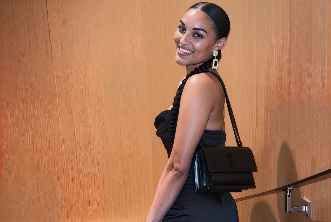 Brianna Johnson poses in a black strapless dress and gold earrings.