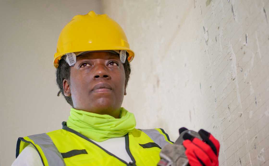 A female mechanical engineer holding a tool A female mechanical engineer holding a tool