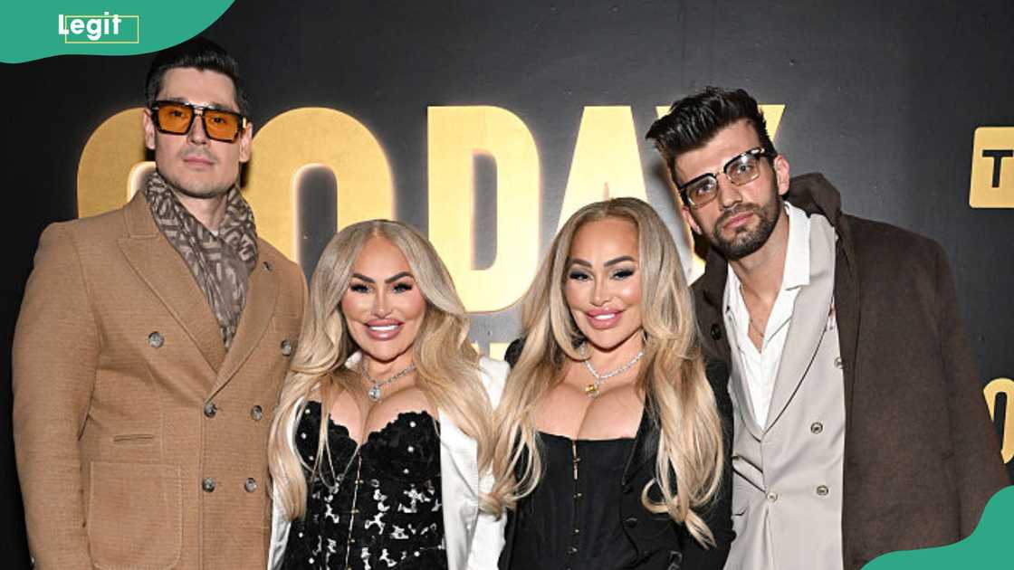Two men and two women pose together in front of a dark backdrop with gold "90 DAY" branding. Two men and two women pose together in front of a dark backdrop with gold "90 DAY" branding.