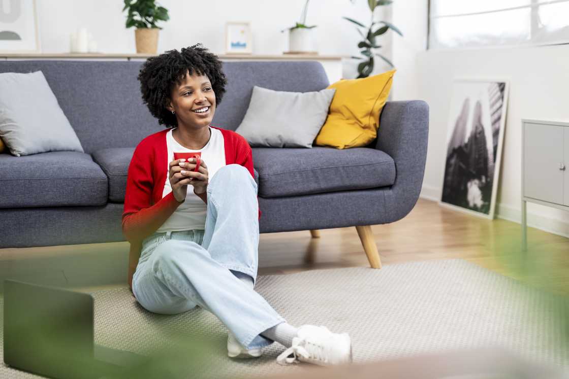 Serene young woman savoring a warm beverage