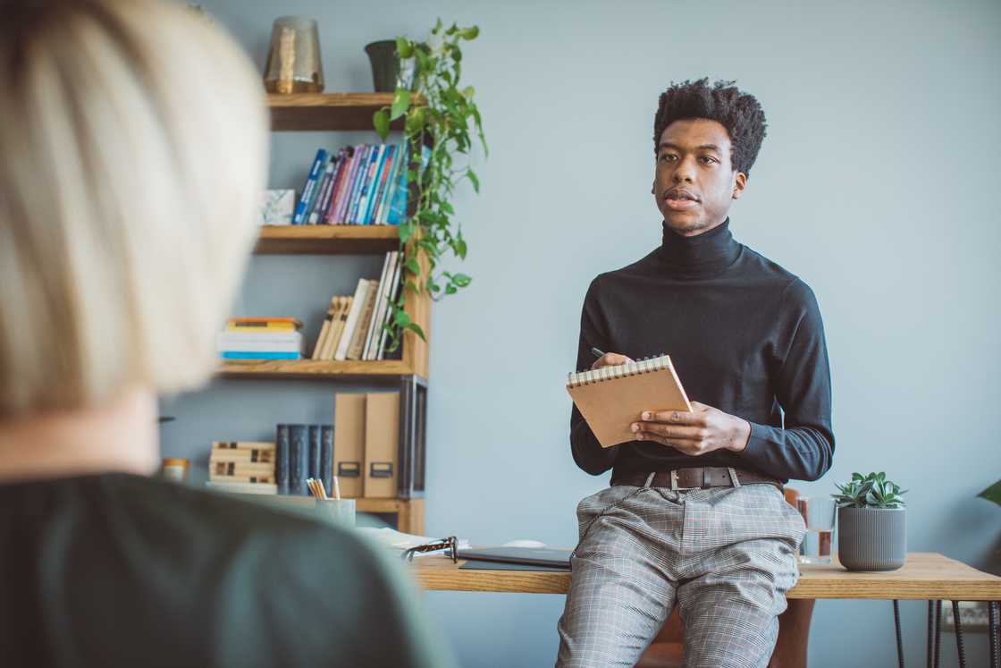 A scriptwriter having meeting with book publisher at the office. A scriptwriter having meeting with book publisher at the office.
