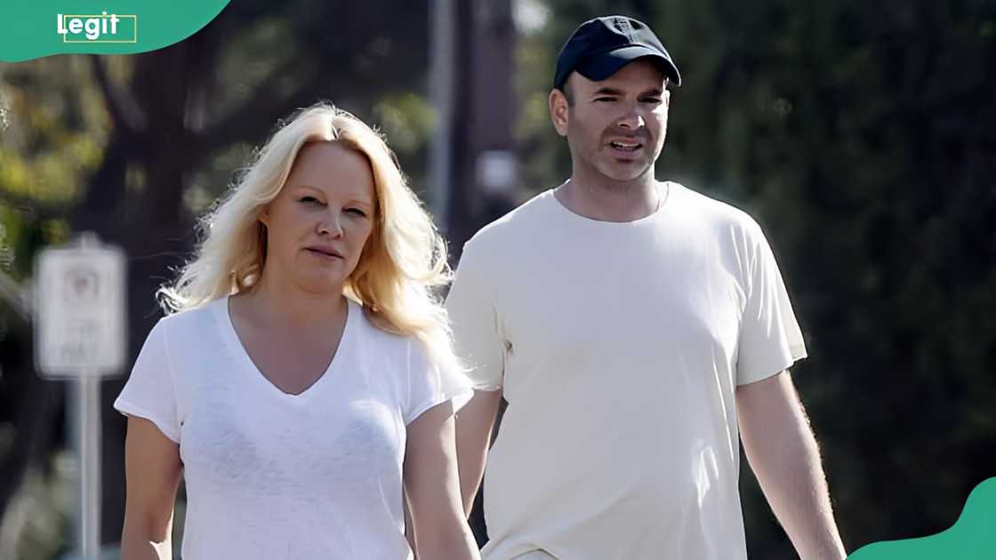 Pamela Anderson and Dan Hayhurst walk together in their neighbourhood Pamela Anderson and Dan Hayhurst walk together in their neighbourhood