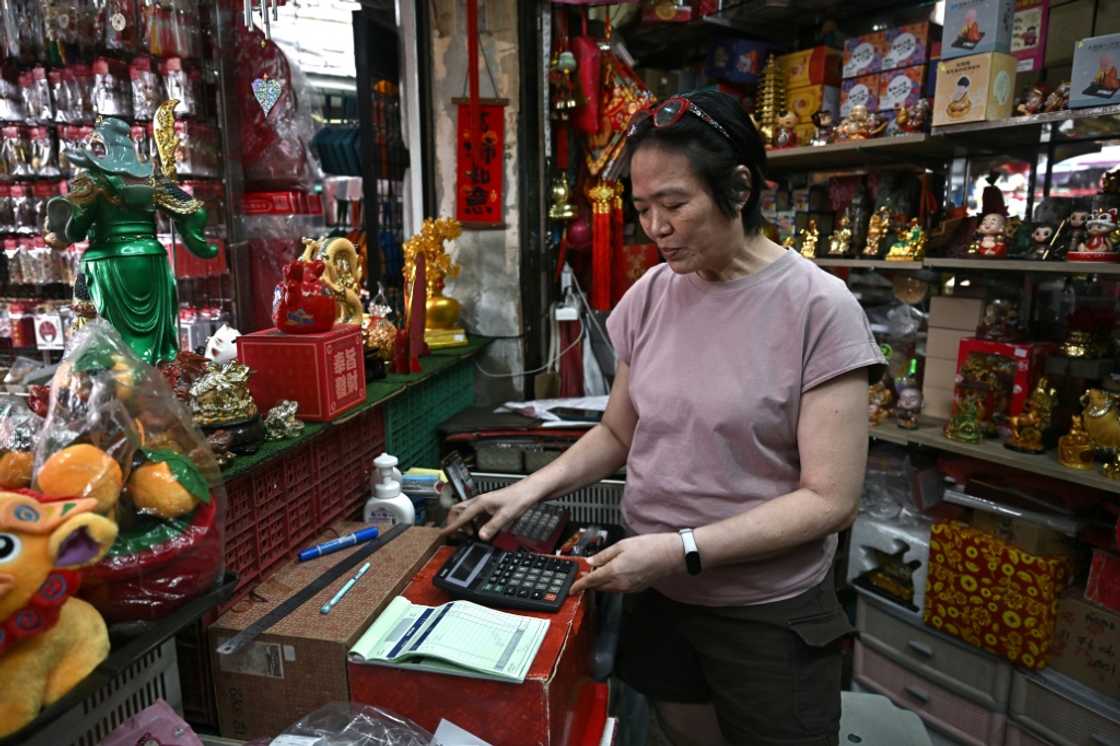 Thitinan Suntisubpool, co-owner of a shop in Bangkok's Chinatown, said she loves how durable her big calculator is Thitinan Suntisubpool, co-owner of a shop in Bangkok's Chinatown, said she loves how durable her big calculator is