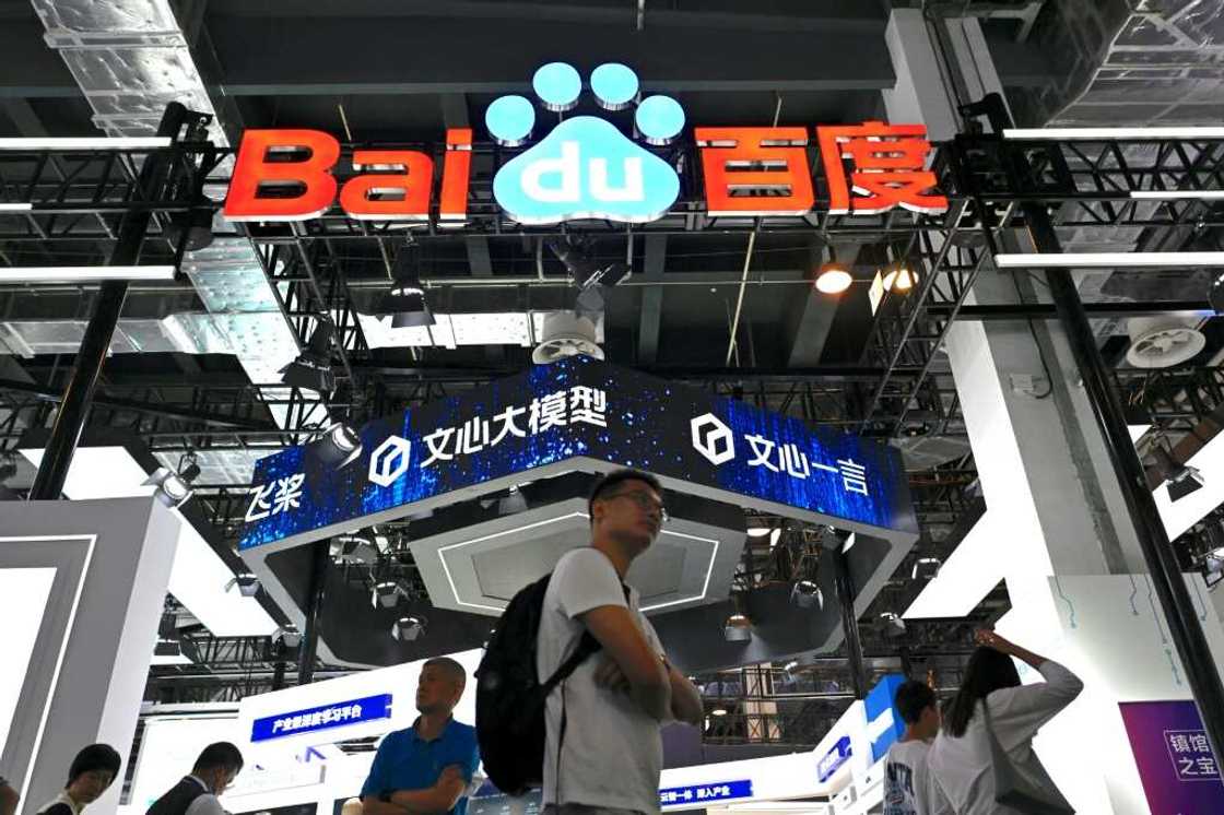 Visitors walk past the Baidu booth during the World Artificial Intelligence Conference (WAIC) in Shanghai Visitors walk past the Baidu booth during the World Artificial Intelligence Conference (WAIC) in Shanghai