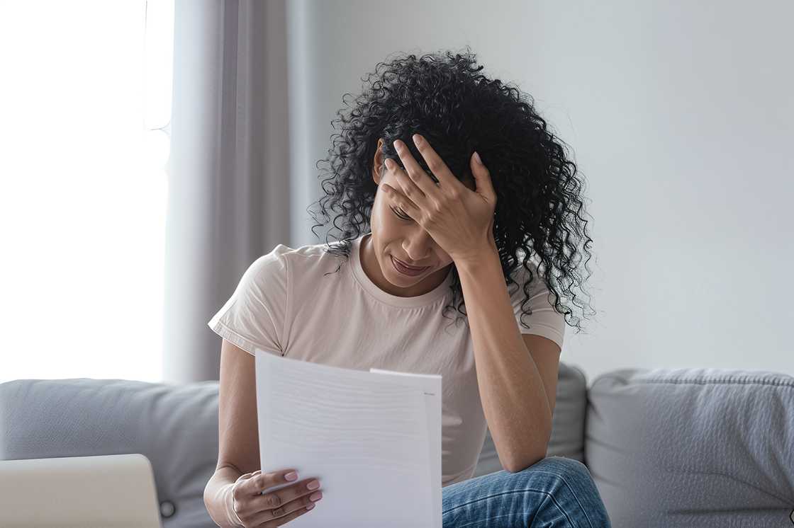 An upset black woman read bad news An upset black woman read bad news