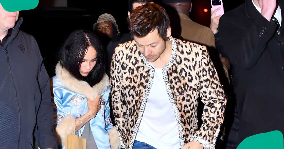 Harry Styles and Zoë Kravitz walk through a crowd. Harry Styles and Zoë Kravitz walk through a crowd.