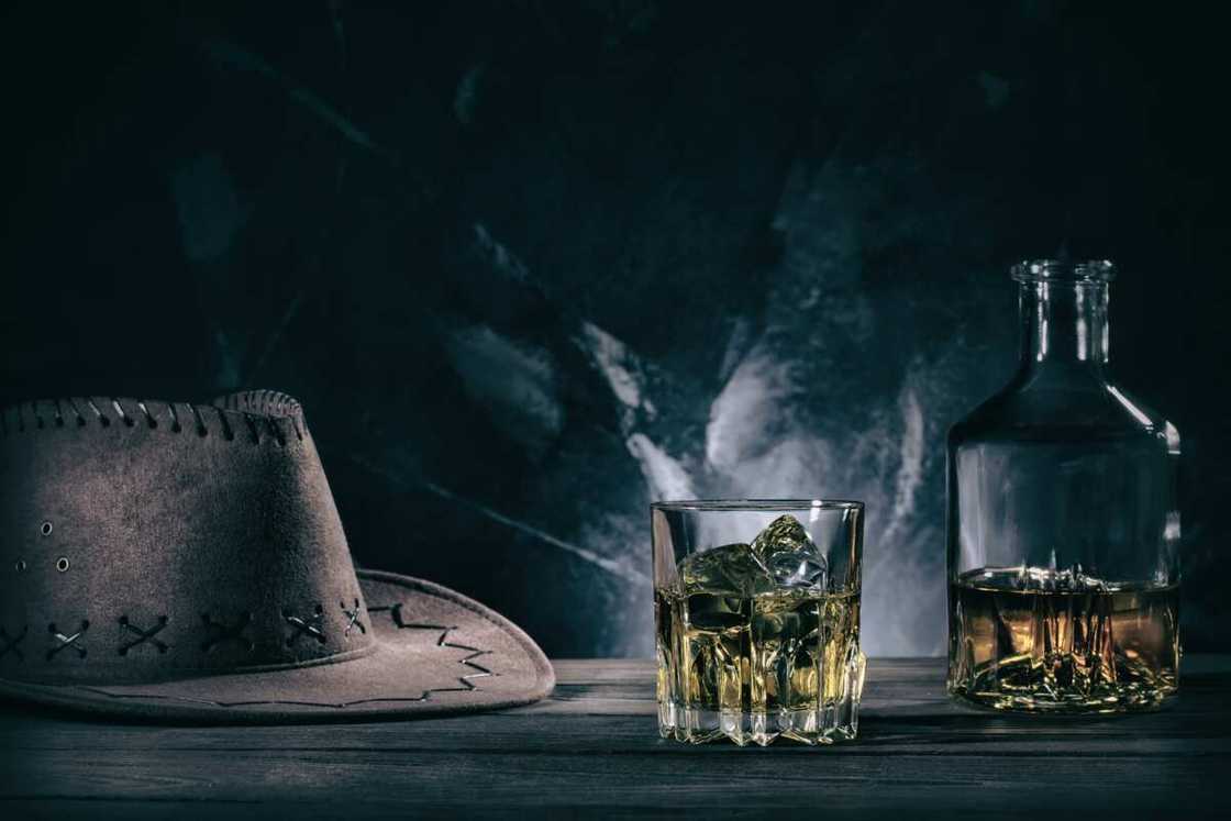 Glass oh whiskey and cowboy hat Glass oh whiskey and cowboy hat