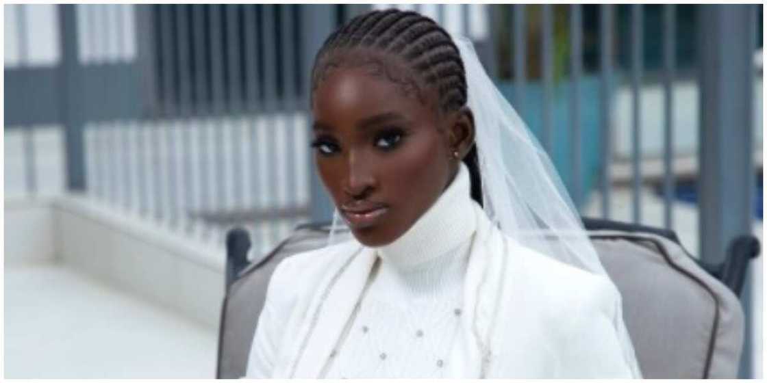 Photo of a model in a white ensemble. Photo of a model in a white ensemble.