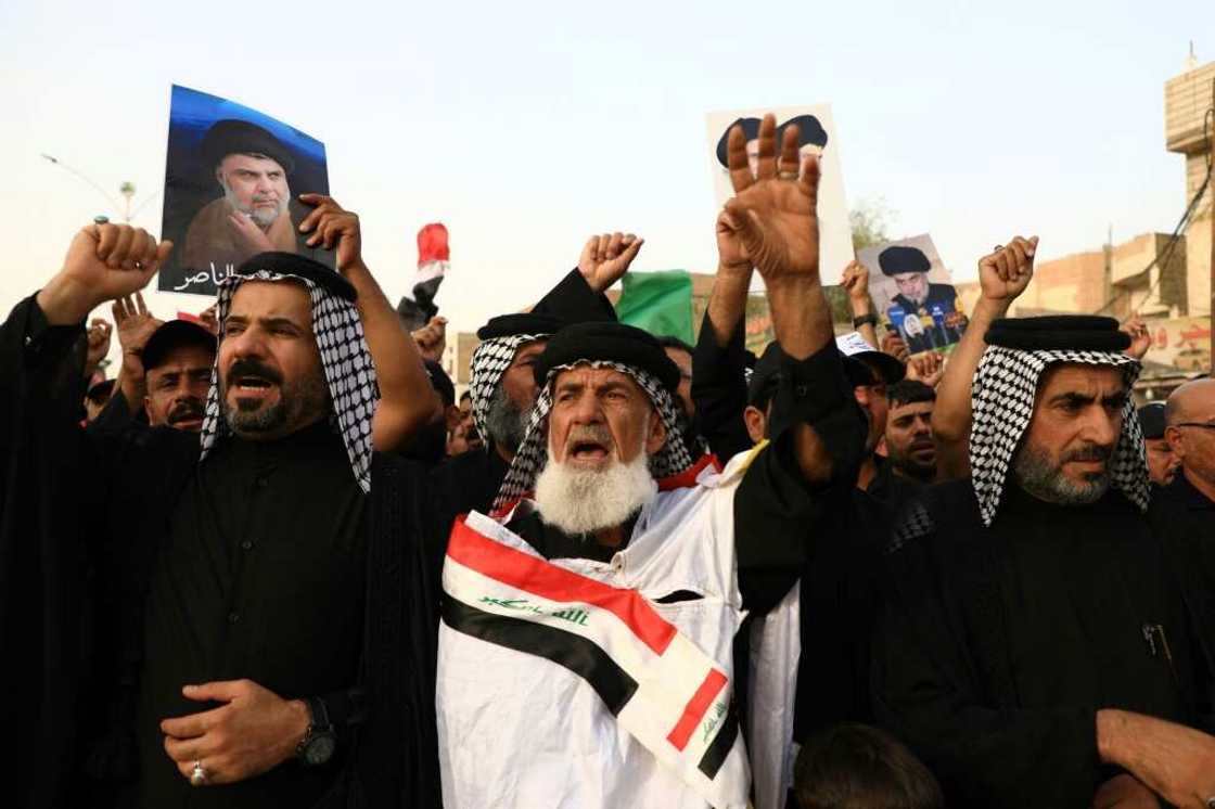 Supporters of Shiite cleric Moqtada Sadr carry portraits of him as they gather in the city of Nasiriyah in Iraq's southern Dhi Qar province Supporters of Shiite cleric Moqtada Sadr carry portraits of him as they gather in the city of Nasiriyah in Iraq's southern Dhi Qar province
