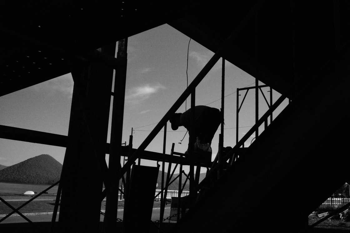 A man climbing a ladder A man climbing a ladder