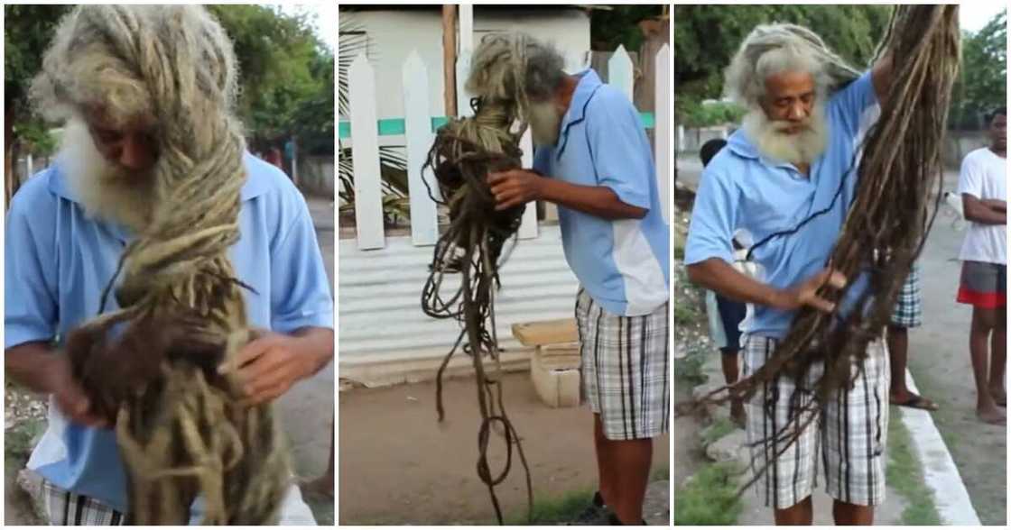 Man posing with his long dreadlocks.