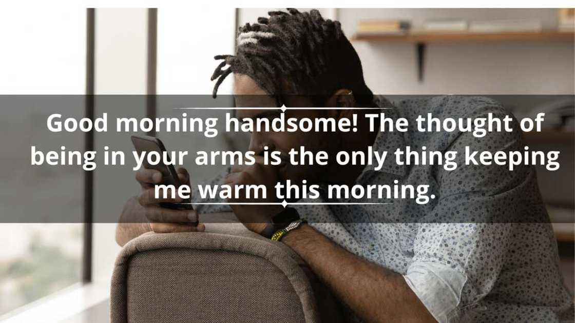 A young man in dreadlocks reads a text while sitting on a brown sofa A young man in dreadlocks reads a text while sitting on a brown sofa