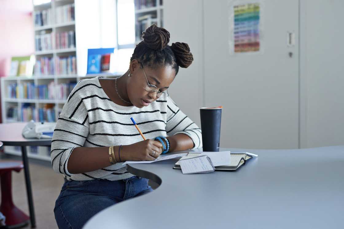 A female university student studying in a library