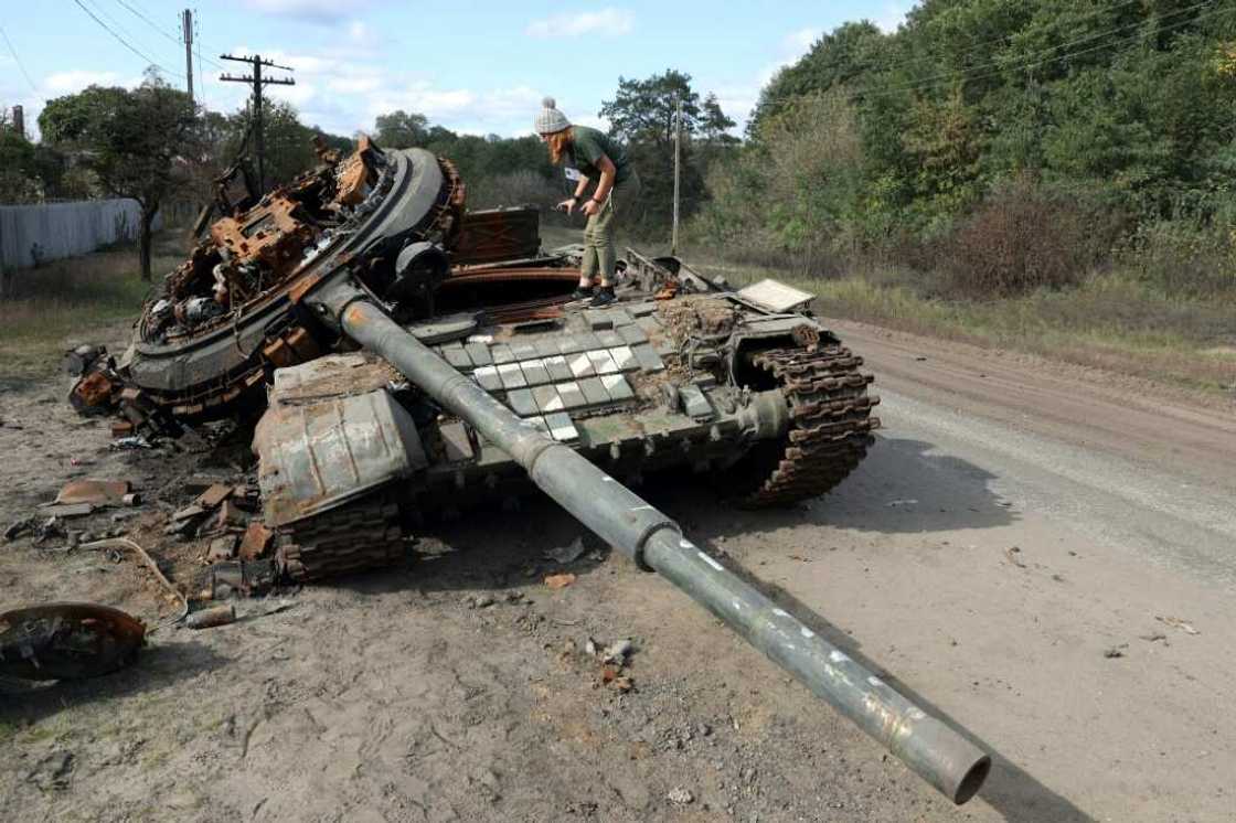 A girl inspects a destroyed Russian tank near the village of Oskol, Kharkiv region A girl inspects a destroyed Russian tank near the village of Oskol, Kharkiv region