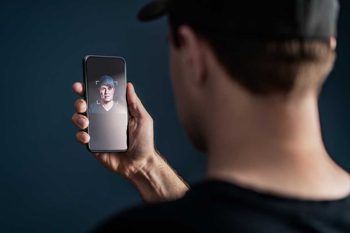A man using the Face ID feature of a phone A man using the Face ID feature of a phone