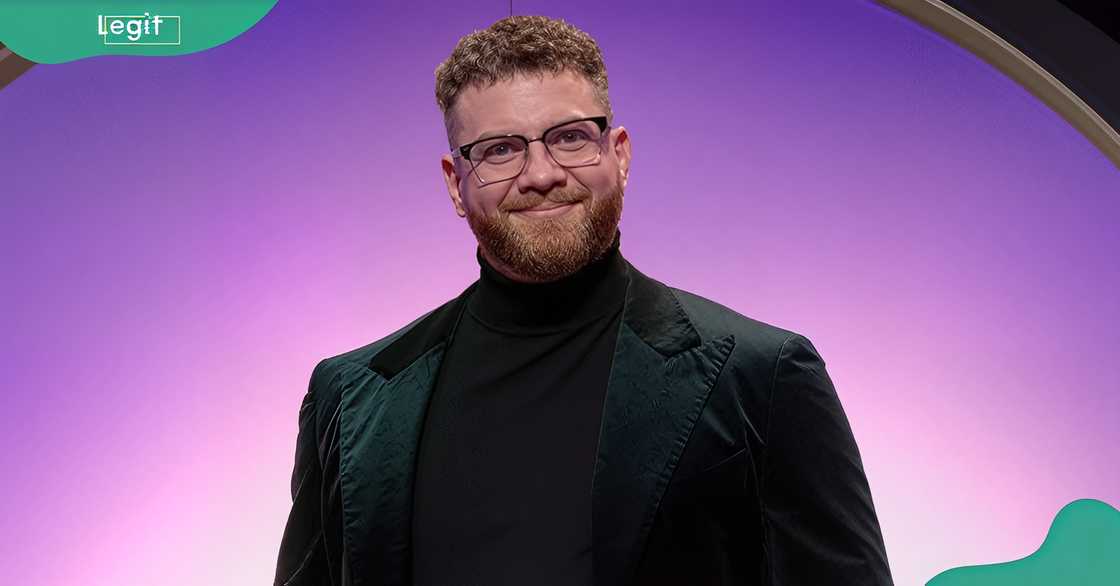 Stephen Richardson poses in front of a purple background Stephen Richardson poses in front of a purple background