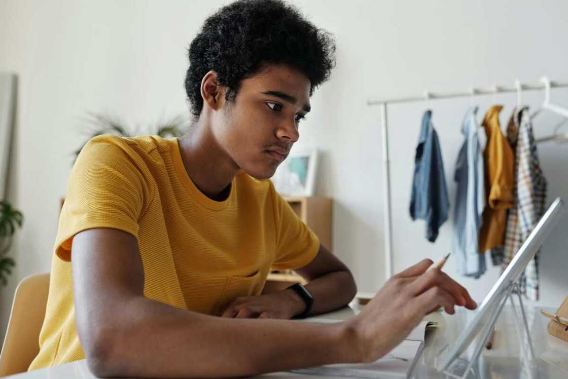 A male students using a tablet A male students using a tablet