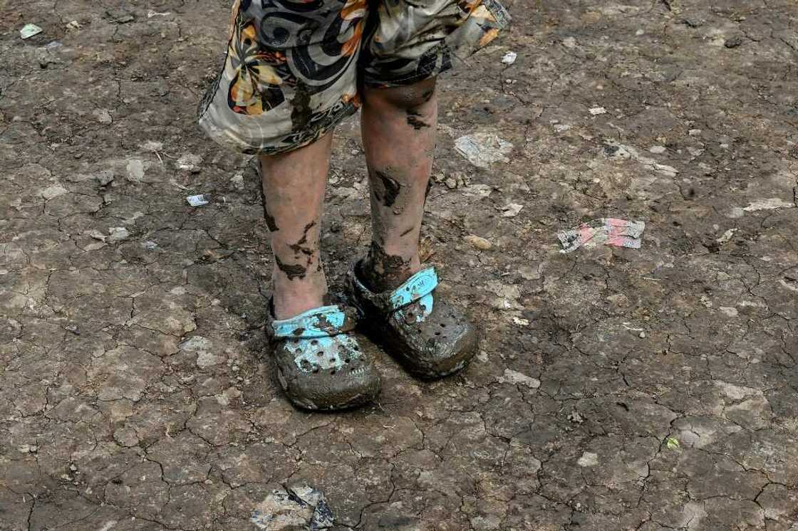 The shoes of a Venezuelan migrant girl are coated in mud after traveling through the Darien Jungle The shoes of a Venezuelan migrant girl are coated in mud after traveling through the Darien Jungle