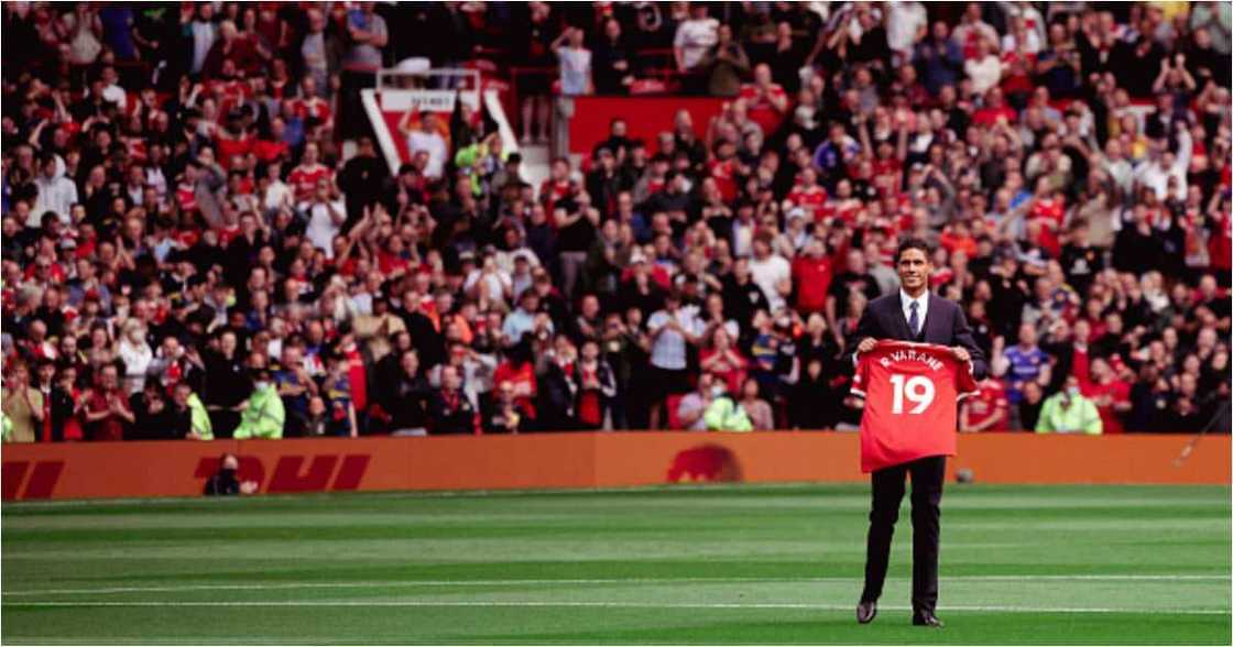 Raphael Varane of Manchester Unite poses with a shirt as he is unveiled prior to the Premier League match between Manchester United and Leeds United at Old Trafford on August 14, 2021. (Photo by Ash Donelon/Manchester United via Getty Images)