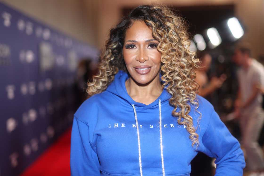 Sheree Whitfield poses in a blue hoodie at the BravoCon 2023